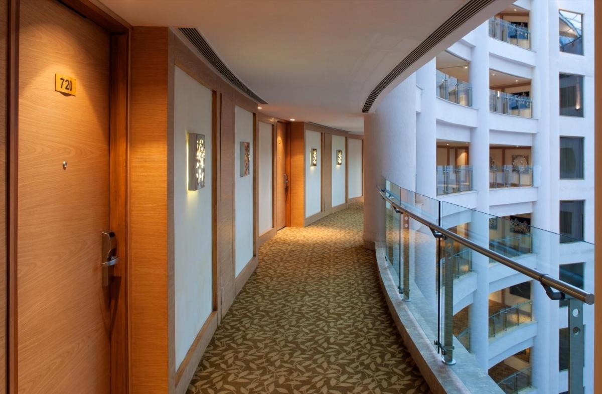a corridor in a building with a hallwayiterator sidx sidx sidxktopktop at Radisson Blu Hotel New Delhi Dwarka in New Delhi a corridor in a building with a hallwayiterator sidx sidx sidxktopktop at Radisson Blu Hotel New Delhi Dwarka in New Delhi