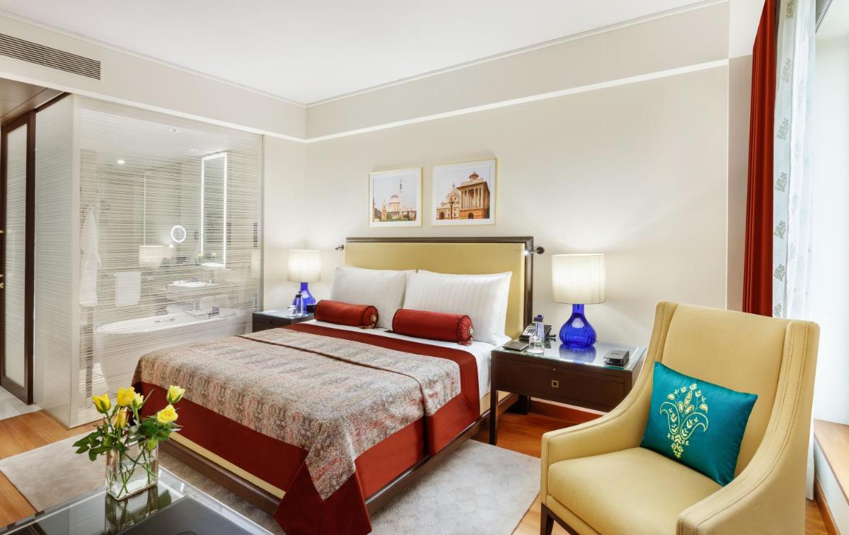 a hotel room with a bed and a chair at The Oberoi New Delhi in New Delhi a hotel room with a bed and a chair at The Oberoi New Delhi in New Delhi