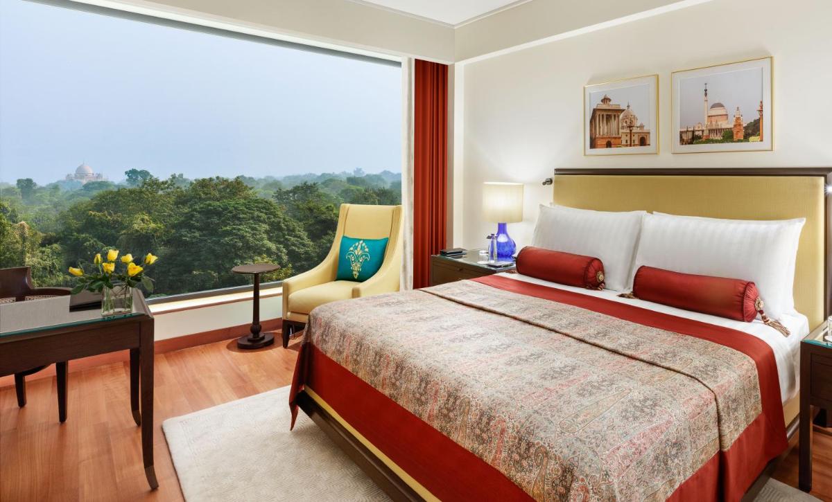 a bedroom with a large bed and a large window at The Oberoi New Delhi in New Delhi +36 photos a bedroom with a large bed and a large window at The Oberoi New Delhi in New Delhi +36 photos