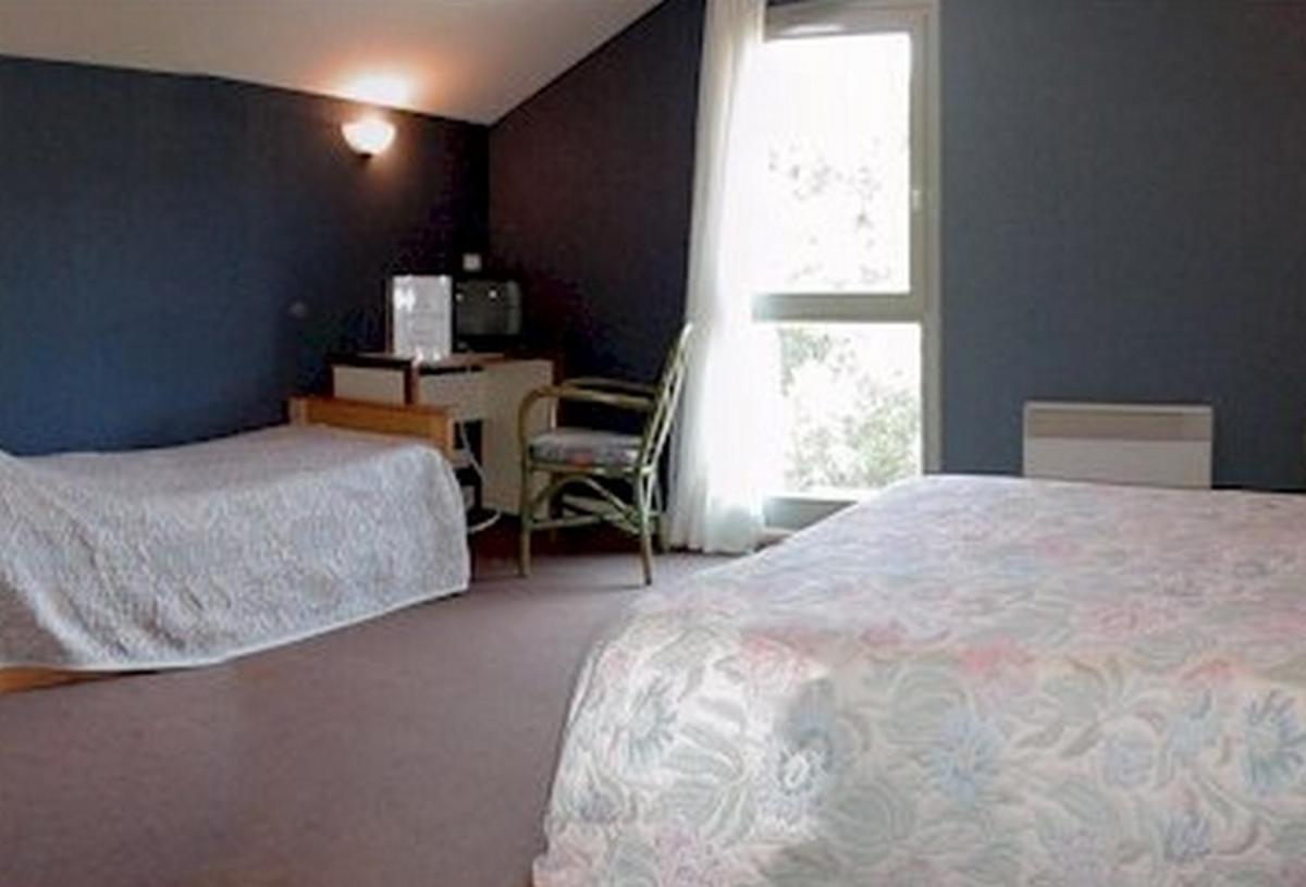 Un ou plusieurs lits dans un hébergement de l'établissement Hôtel du Bout du Monde