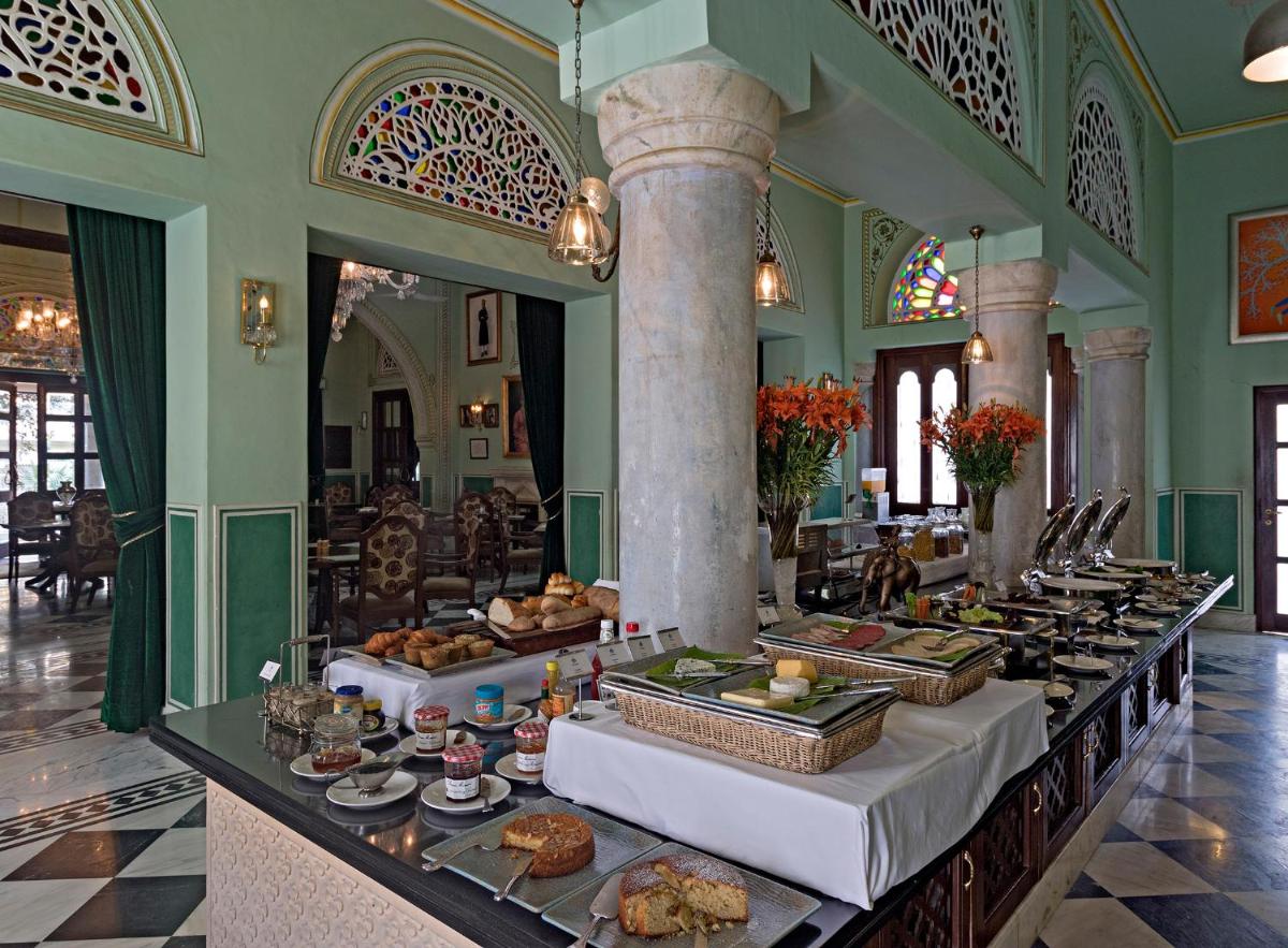 a buffet line with food on it in a building at Samode Haveli in Jaipur