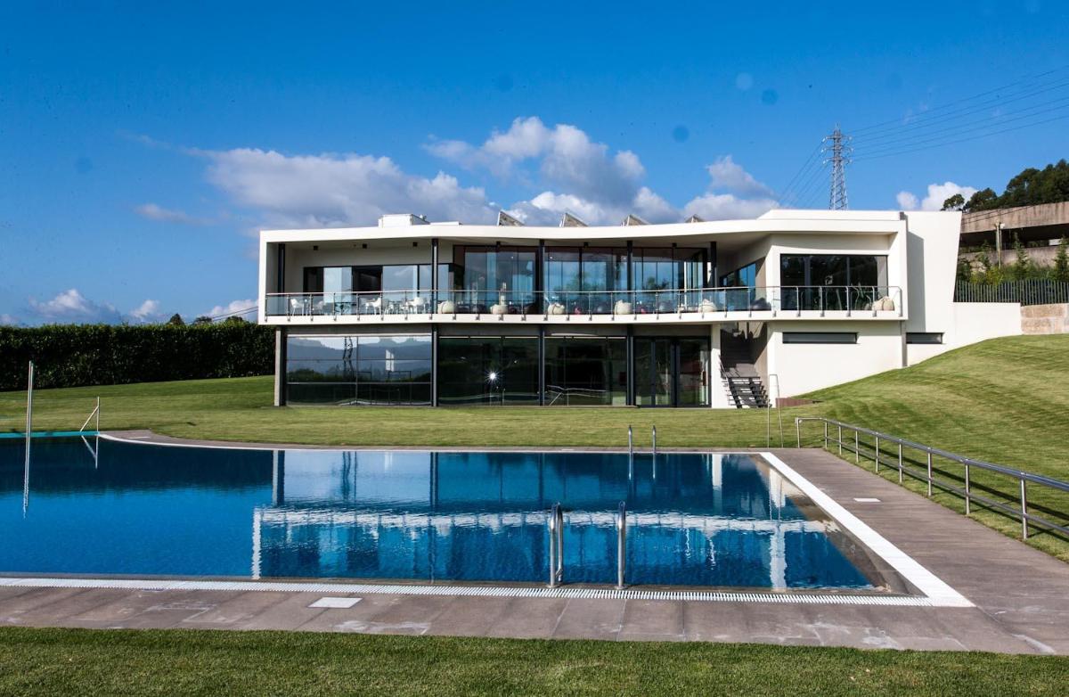 uma casa com uma piscina na frente em Paraíso Villas & Spa em Guimarães mais 44 fotografias