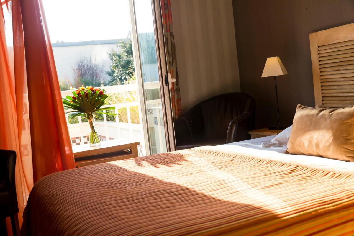 Un ou plusieurs lits dans un hébergement de l'établissement Almoria Hôtel & SPA