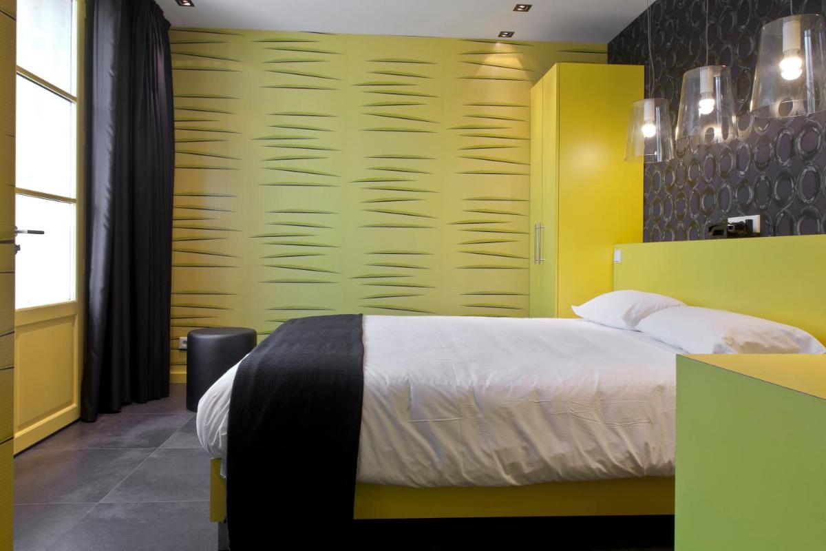 Un ou plusieurs lits dans un hébergement de l'établissement Hôtel Montmorency & Spa