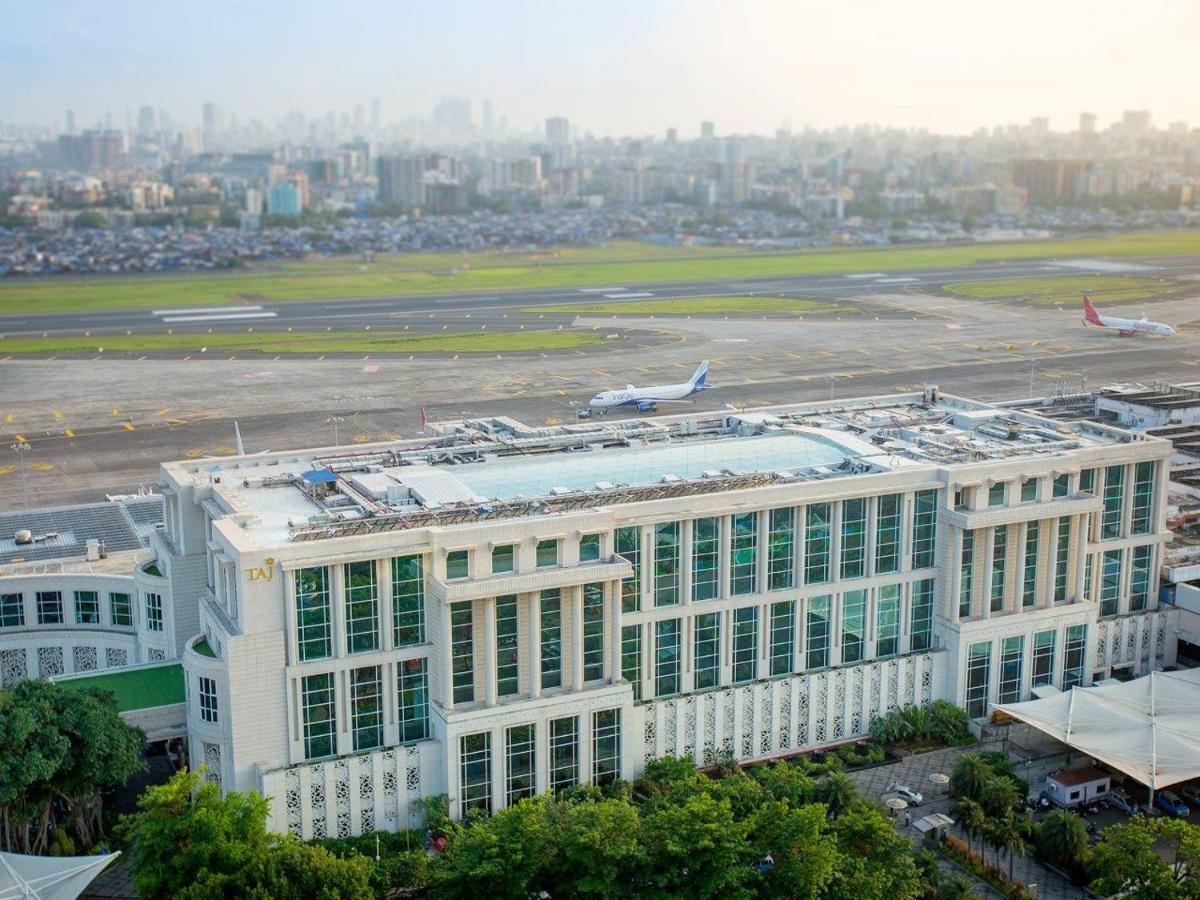 a large white building with a runway and an airport at Taj Santacruz in Mumbai