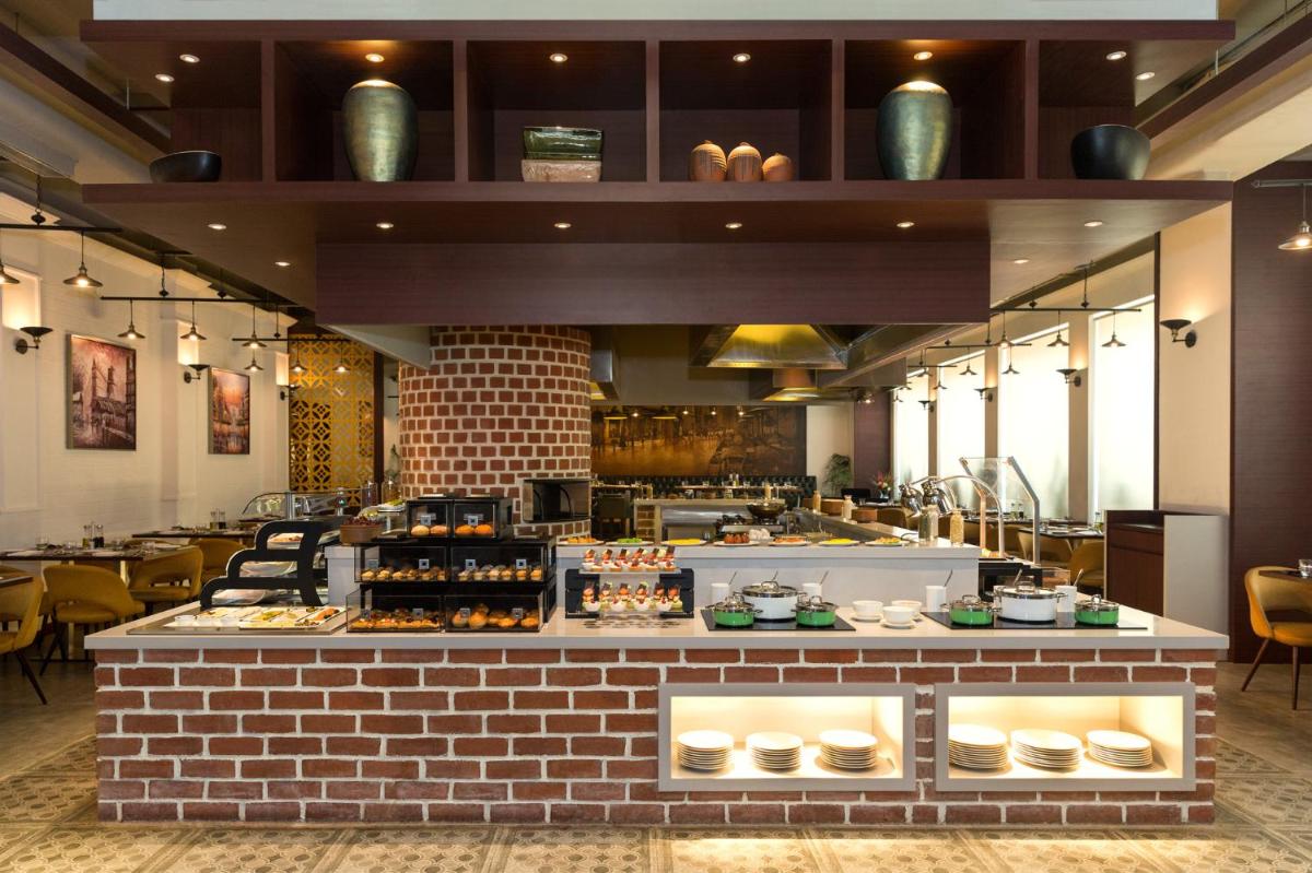 a restaurant with a brick counter with food on it at The Accord Metropolitan in Chennai