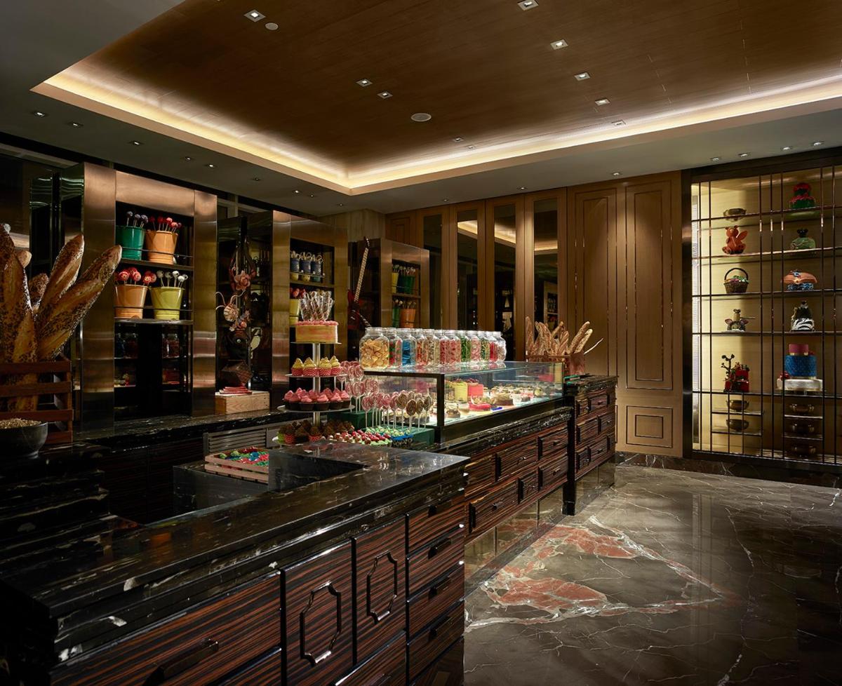 a room with a counter with many different items at Shangri-La Bengaluru in Bengaluru a room with a counter with many different items at Shangri-La Bengaluru in Bengaluru