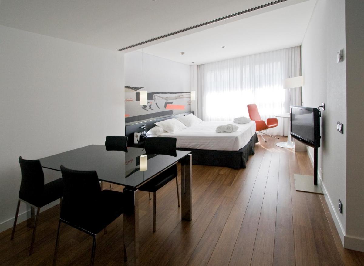 Una habitación de hotel con una cama y un escritorio con un escritorio en Axor Barajas, en Madrid