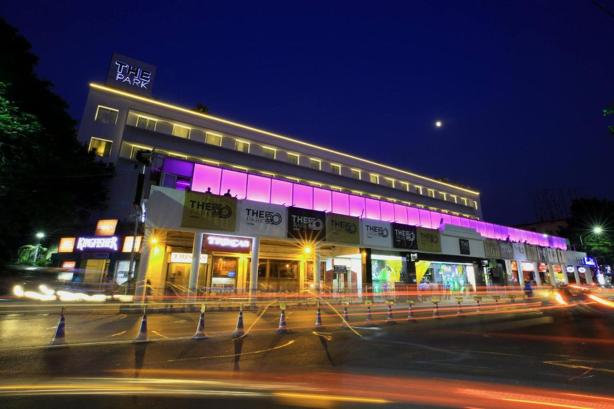a building with purple lights on a street at night at The Park Kolkata in Kolkata
