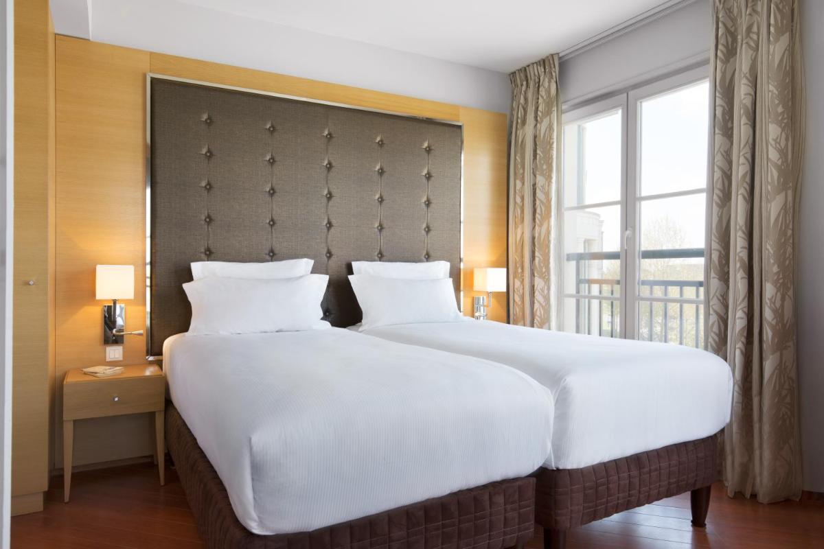 Un ou plusieurs lits dans un hébergement de l'établissement Relais Spa Val d'Europe
