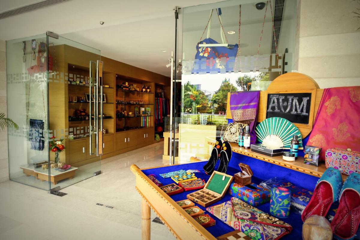 a store with a blue couch in front of a window at The Lalit Chandigarh in Chandīgarh