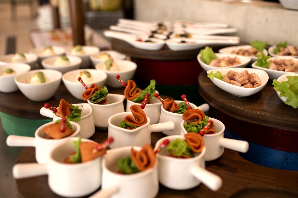 a row of dishes of food on a table at The Lalit Chandigarh in Chandīgarh