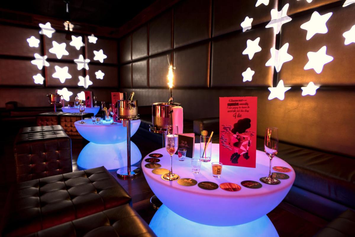 a restaurant with two tables with donuts and stars on the wall at The Lalit Chandigarh in Chandīgarh