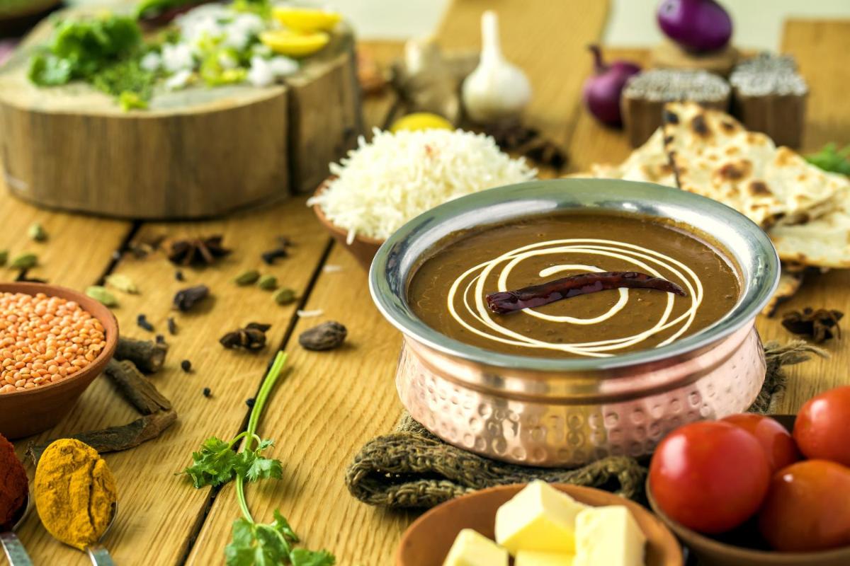 a table with a jar of dip and some food at The Lalit Chandigarh in Chandīgarh