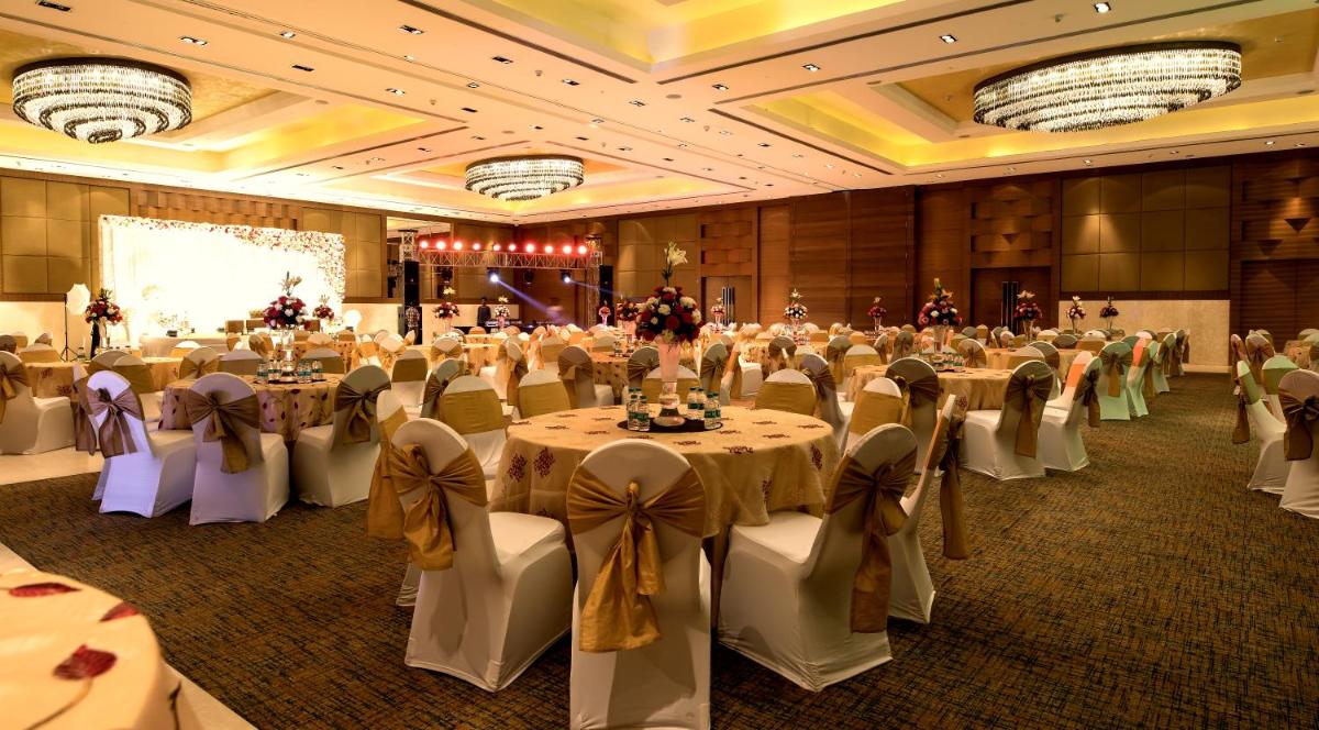 a banquet hall with tables and chairs in a room at The Lalit Chandigarh in Chandīgarh
