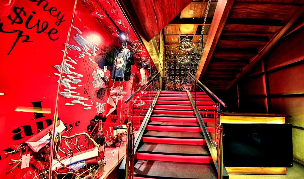 a stairway with red stairs and a red wall at The Lalit Chandigarh in Chandīgarh