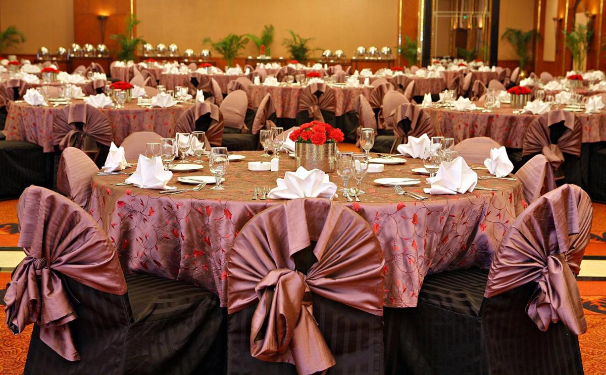 a group of tables in a banquet hall at Eros Hotel New Delhi, Nehru Place in New Delhi a group of tables in a banquet hall at Eros Hotel New Delhi, Nehru Place in New Delhi