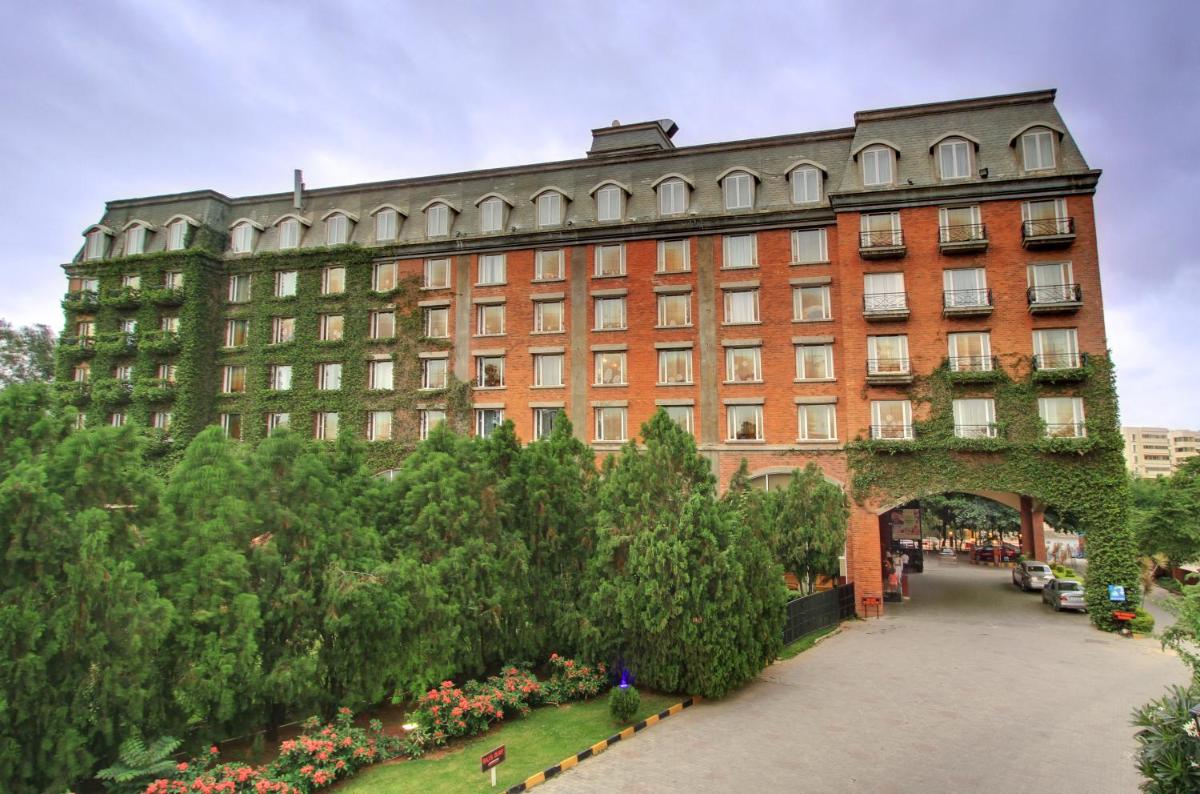 a large brick building with an archway in front of it at Hotel Royal Orchid Bangalore in Bengaluru