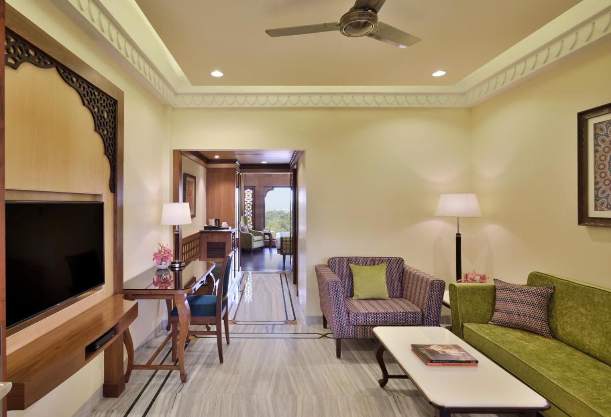a living room with a couch and a tv at Radisson Jodhpur in Jodhpur