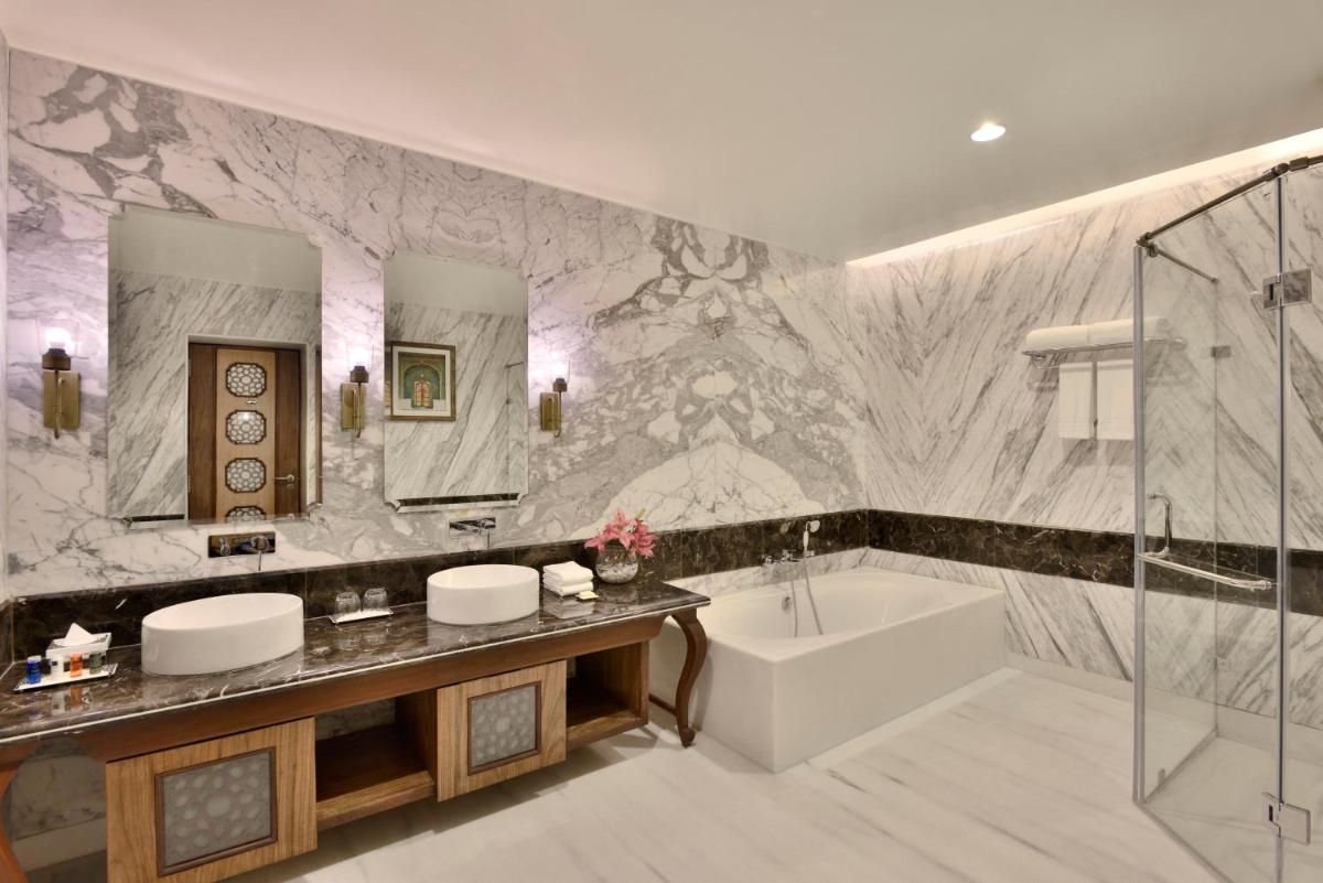 a bathroom with a tub and a sink and a bath tub at Radisson Jodhpur in Jodhpur