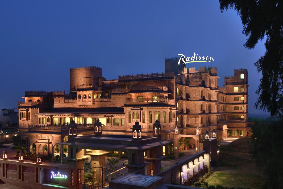 a large building with people standing in front of it at Radisson Jodhpur in Jodhpur