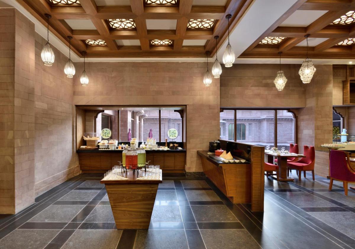 a restaurant with tables and chairs in a room at Radisson Jodhpur in Jodhpur
