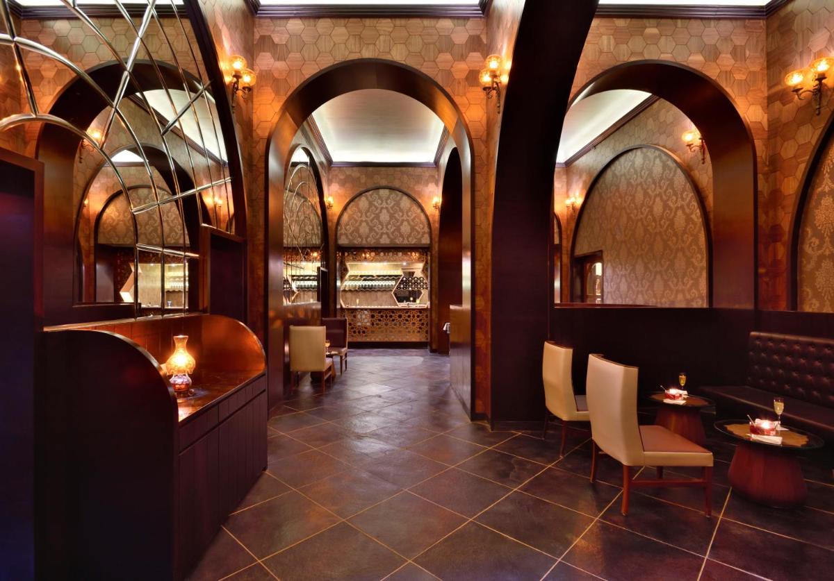 a lobby of a restaurant with arches and tables at Radisson Jodhpur in Jodhpur