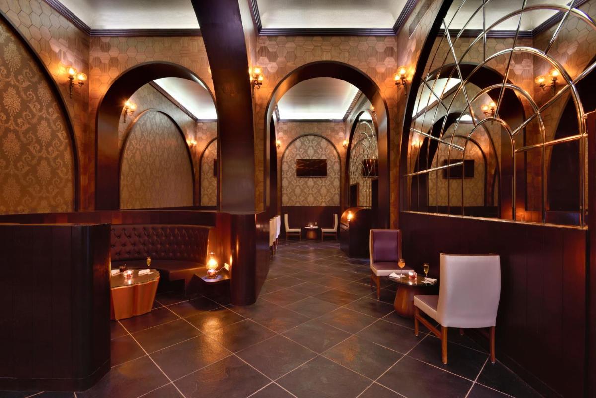 a restaurant with arches and tables and chairs at Radisson Jodhpur in Jodhpur