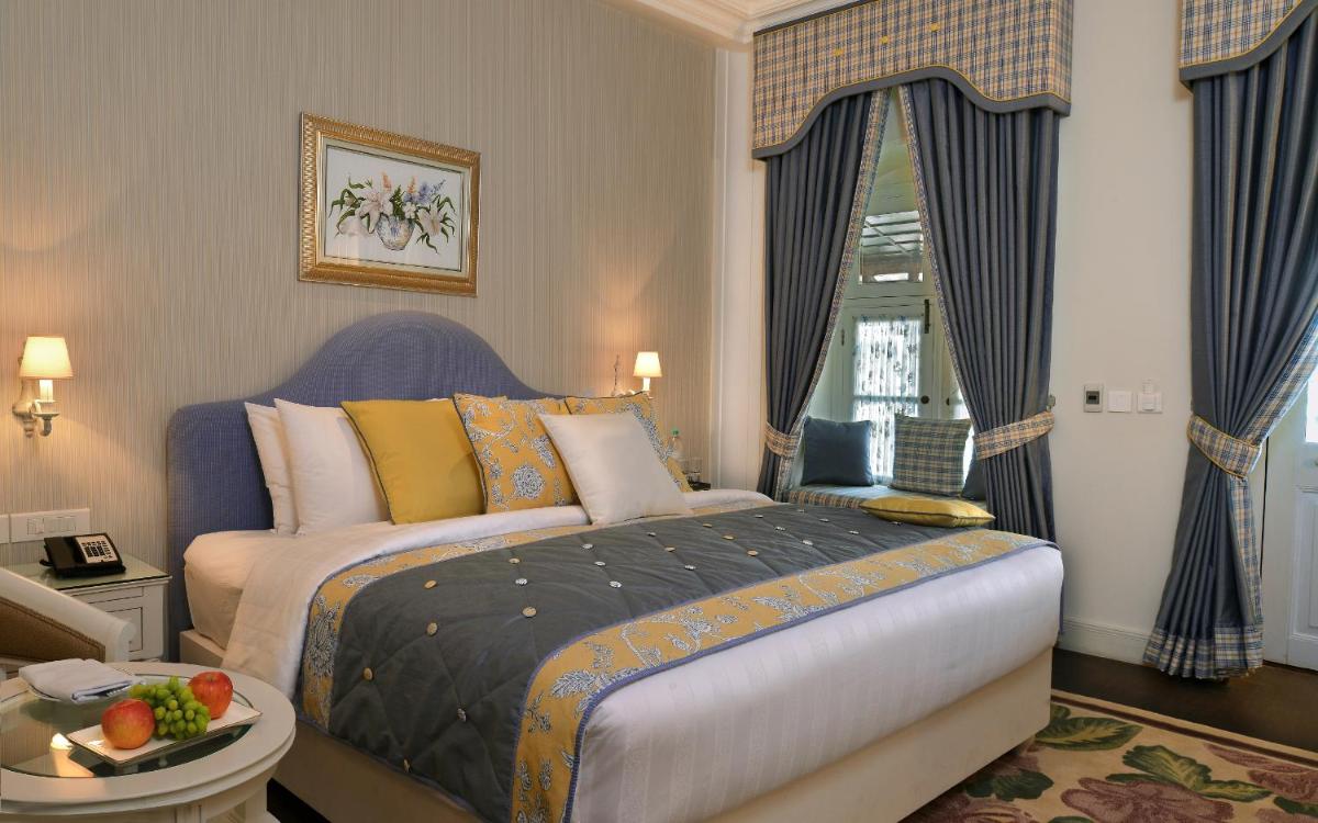 a bedroom with a large bed and a window at Welcomhotel by ITC Hotels, The Savoy, Mussoorie in Mussoorie