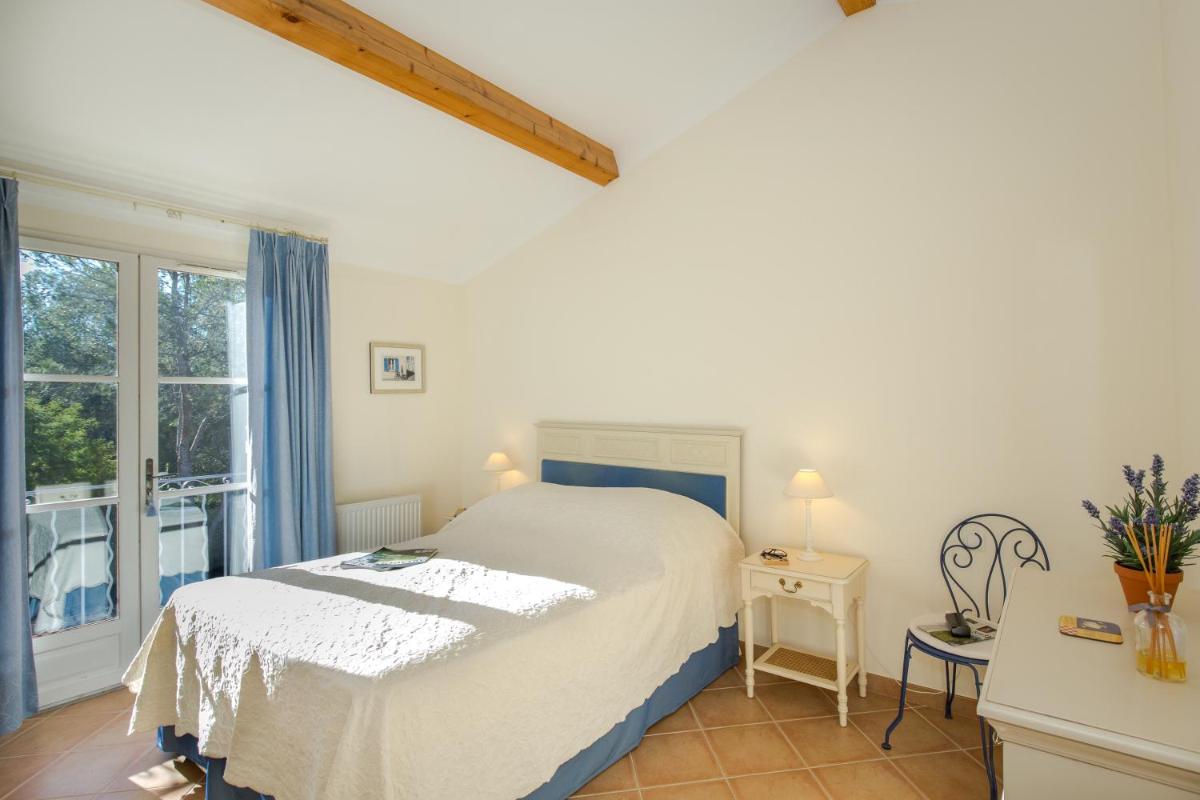 Un ou plusieurs lits dans un hébergement de l'établissement Les Appartements et Maisons du Domaine de Saint Endréol Golf & Spa Resort