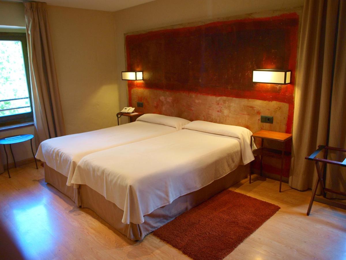 Cama o camas de una habitación en Hotel Santa Cristina Petit Spa