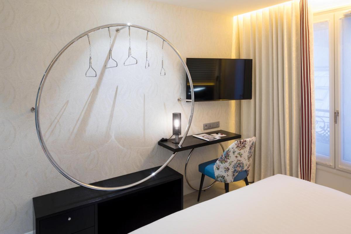 Un ou plusieurs lits dans un hébergement de l'établissement Hôtel Dress Code