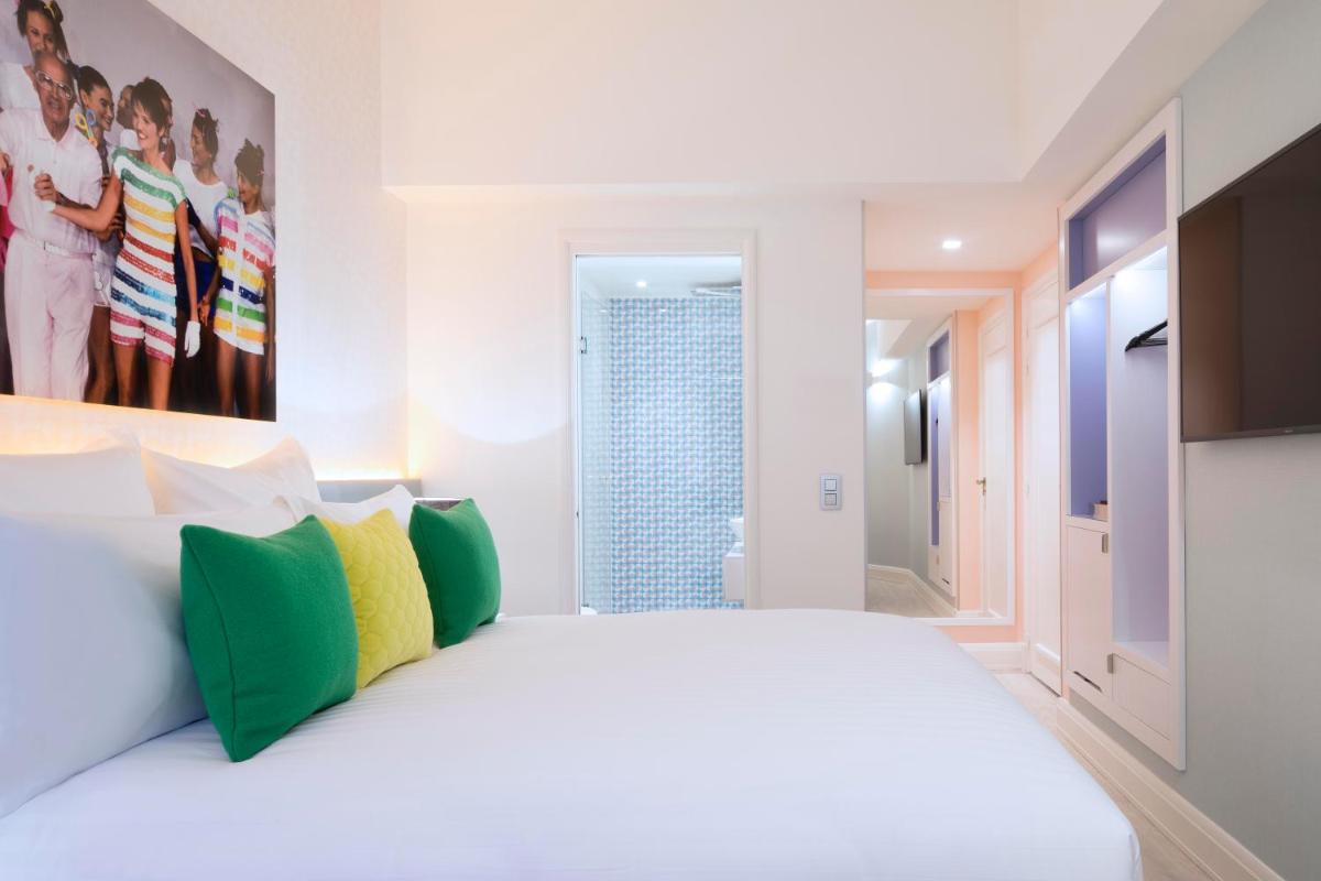 Un ou plusieurs lits dans un hébergement de l'établissement Hôtel Dress Code