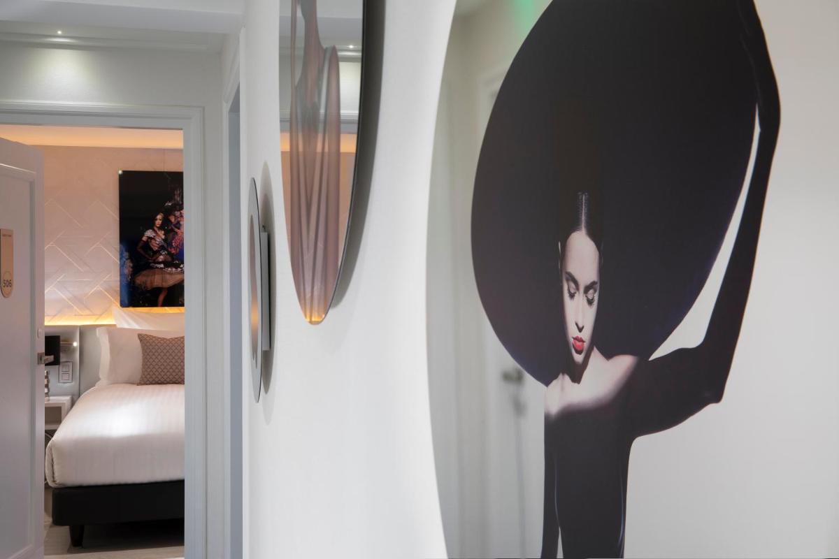 Un ou plusieurs lits dans un hébergement de l'établissement Hôtel Dress Code