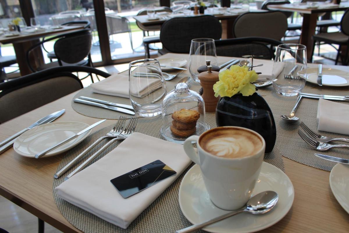 a table with a cup of coffee on top of it at The Den, Bengaluru in Bengaluru