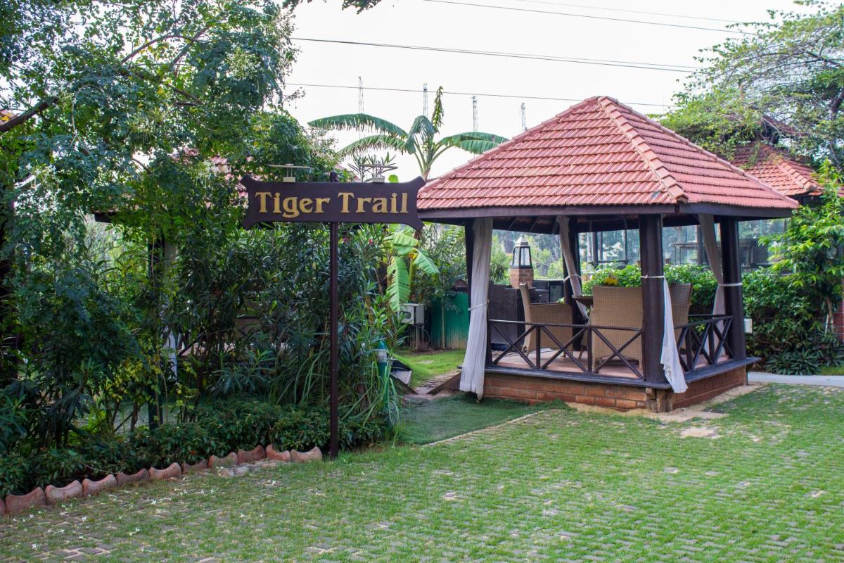 a gazebo with a sign that reads tiger trail at Hotel Royal Orchid Bangalore in Bengaluru