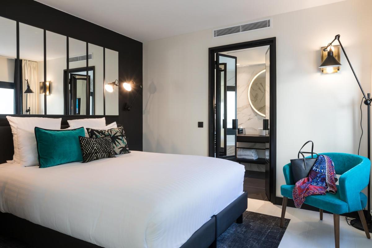 Un ou plusieurs lits dans un hébergement de l'établissement Laz' Hotel Spa Urbain Paris