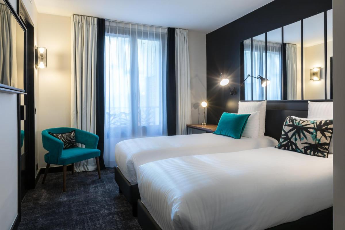 Un ou plusieurs lits dans un hébergement de l'établissement Laz' Hotel Spa Urbain Paris