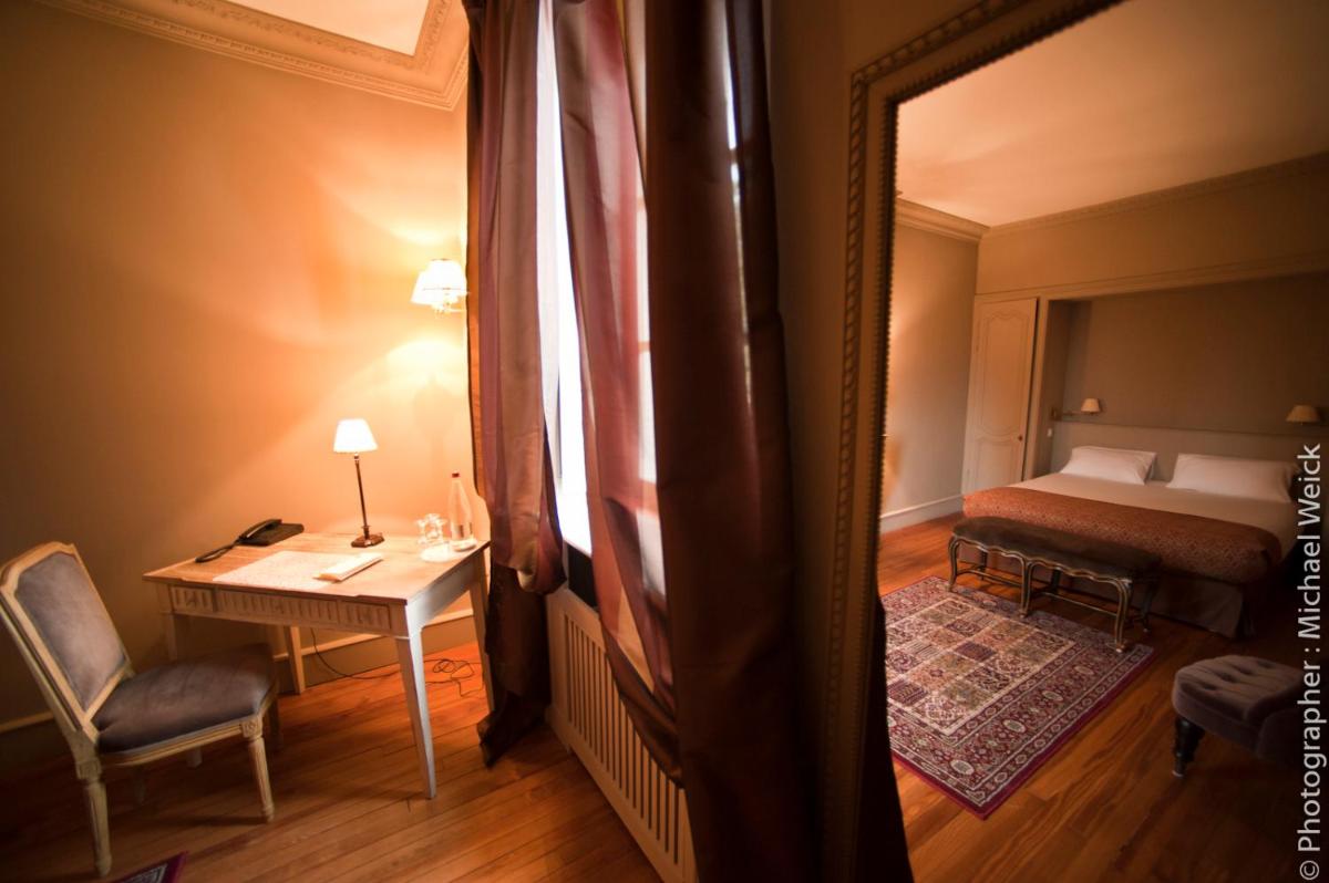 Un ou plusieurs lits dans un hébergement de l'établissement Hôtel Restaurant Spa Le Sauvage