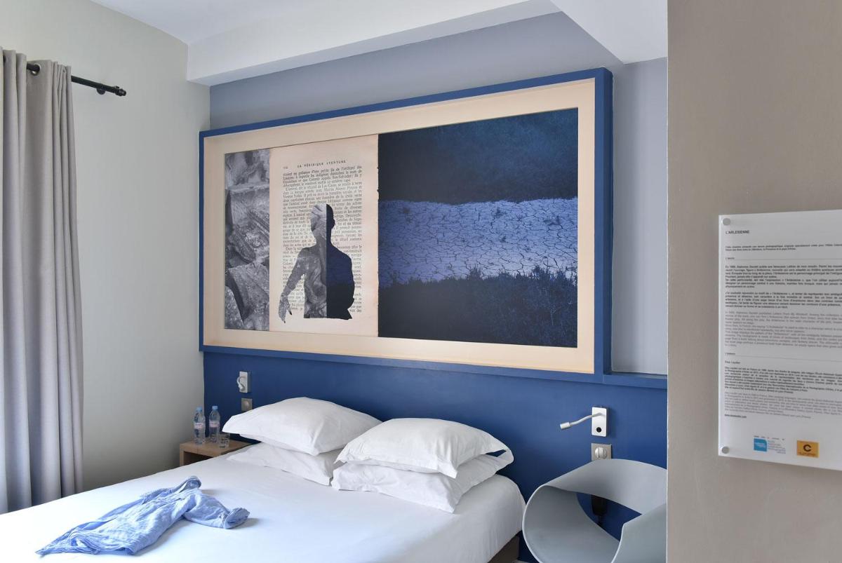 Un ou plusieurs lits dans un hébergement de l'établissement Hotel Spa Le Calendal