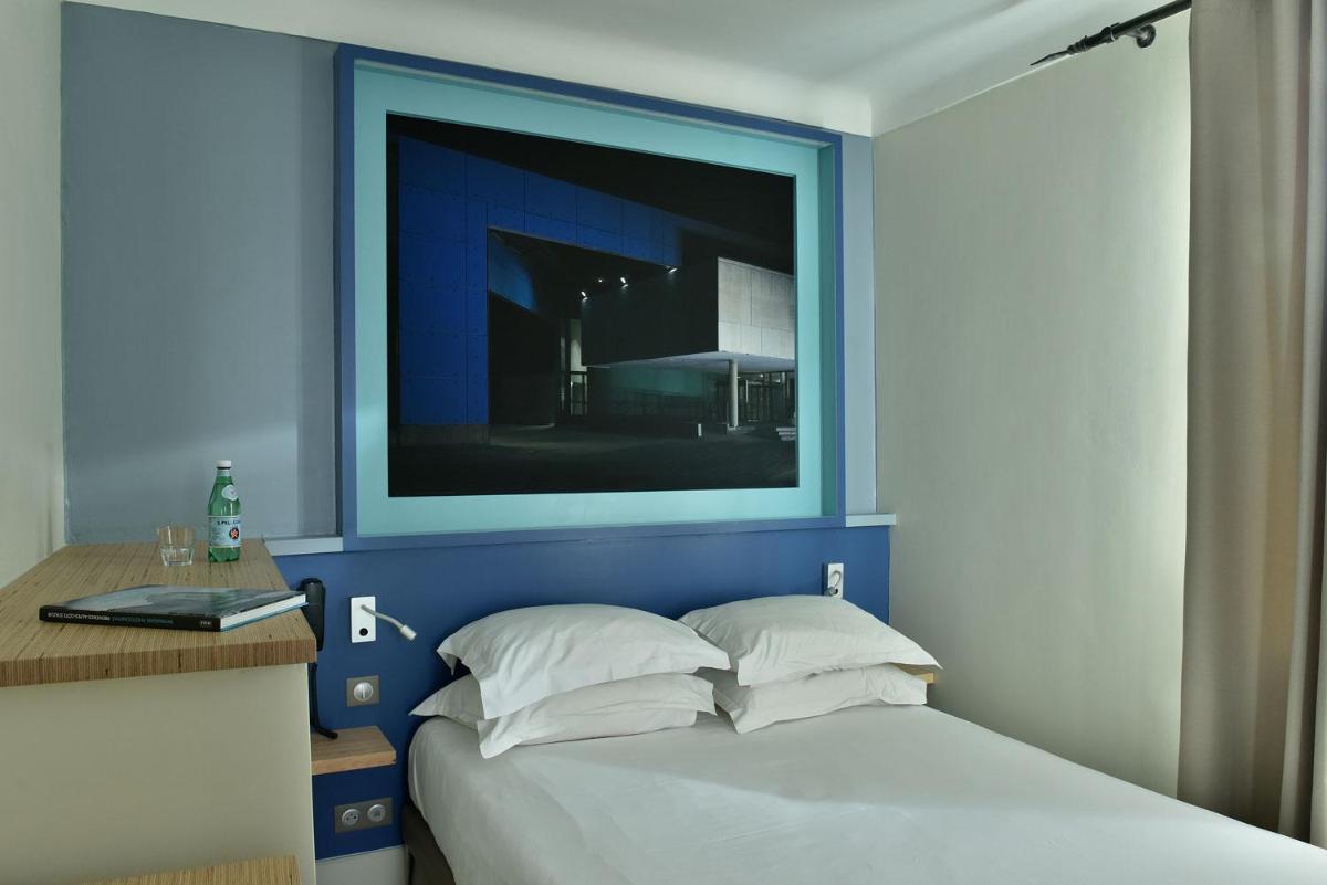 Un ou plusieurs lits dans un hébergement de l'établissement Hotel Spa Le Calendal