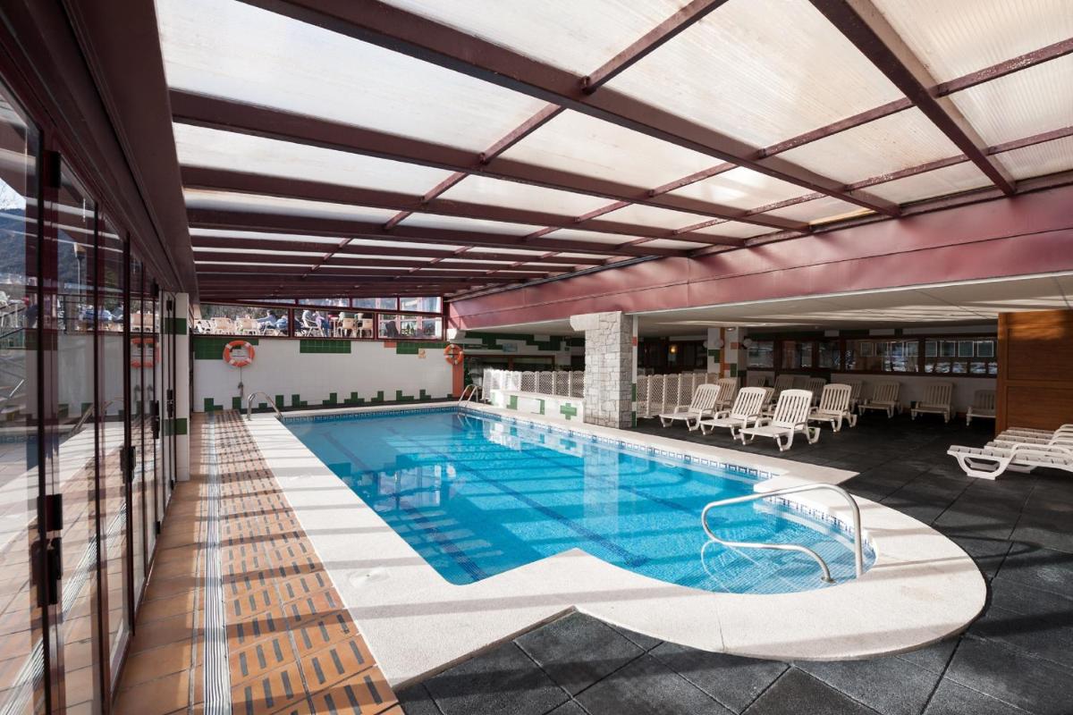 una piscina en medio de un edificio en SOMMOS Hotel Benasque Spa, en Benasque