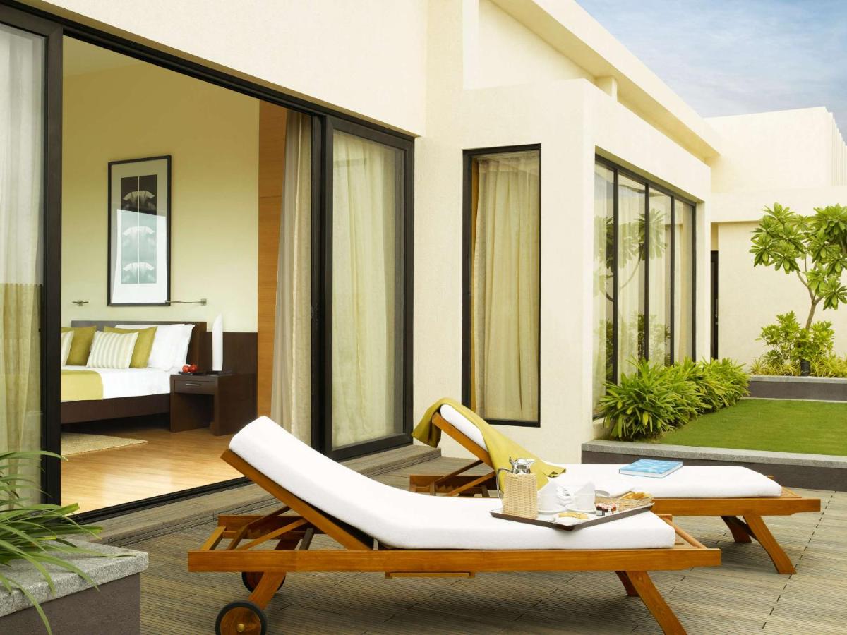 a patio with a couch and a table at Hyatt Hyderabad Gachibowli in Hyderabad