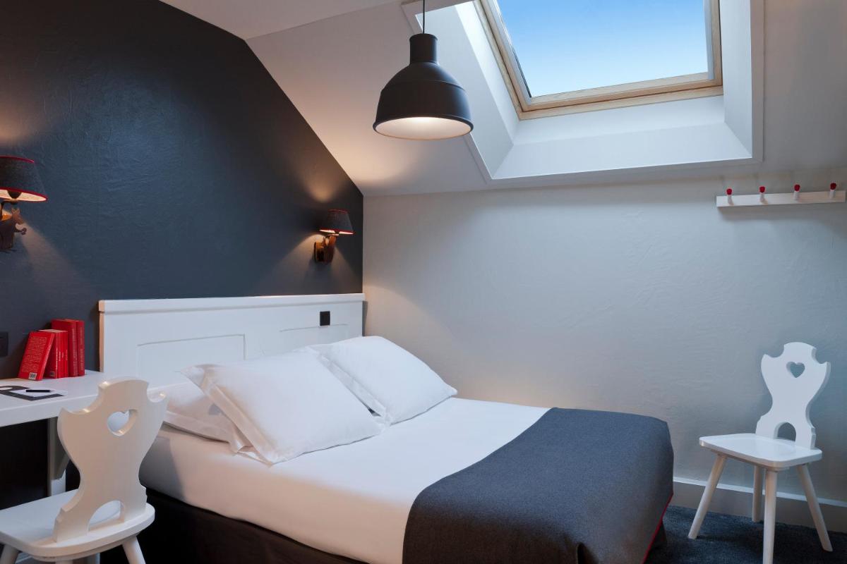 Un ou plusieurs lits dans un hébergement de l'établissement Le Faucigny - Hotel de Charme & SPA