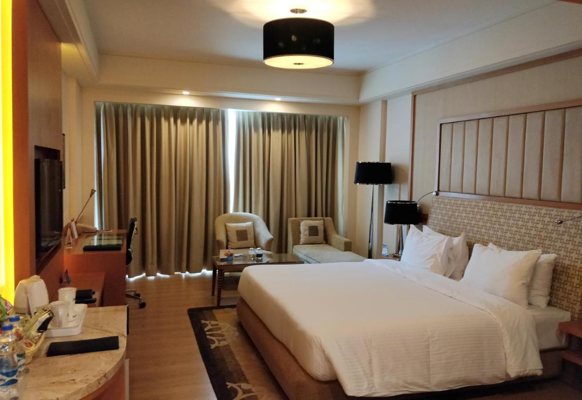a bedroom with a large white bed in a room at Radisson Blu Hotel, Nagpur in Nagpur