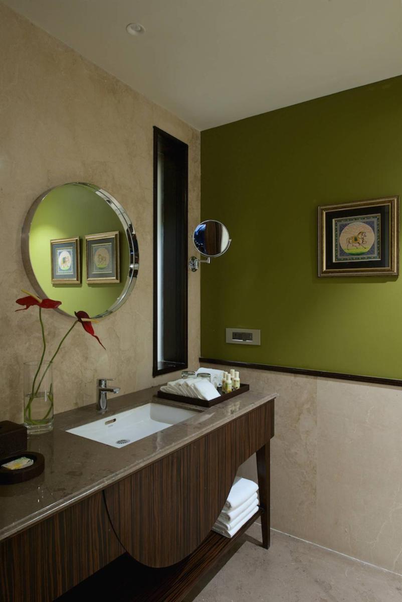 a bathroom with a sink and a mirror at Hotel Lakend in Udaipur