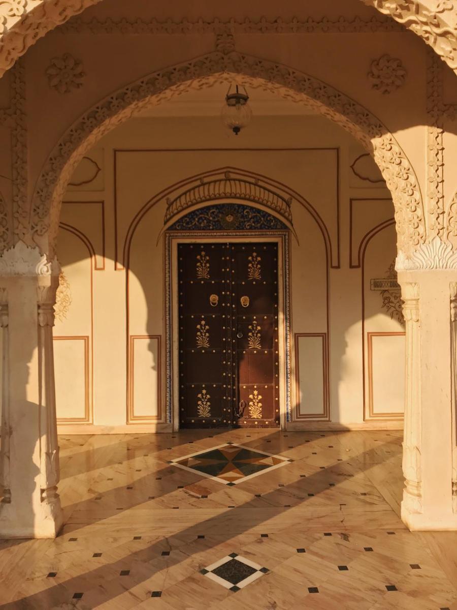 an empty room with a door in a building at The Raj Palace (Small Luxury Hotels of the World) in Jaipur