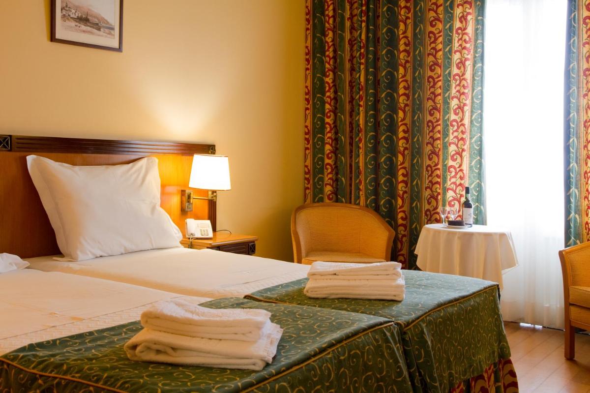 Uma cama ou camas num quarto em Hotel Quinta Bela S Tiago