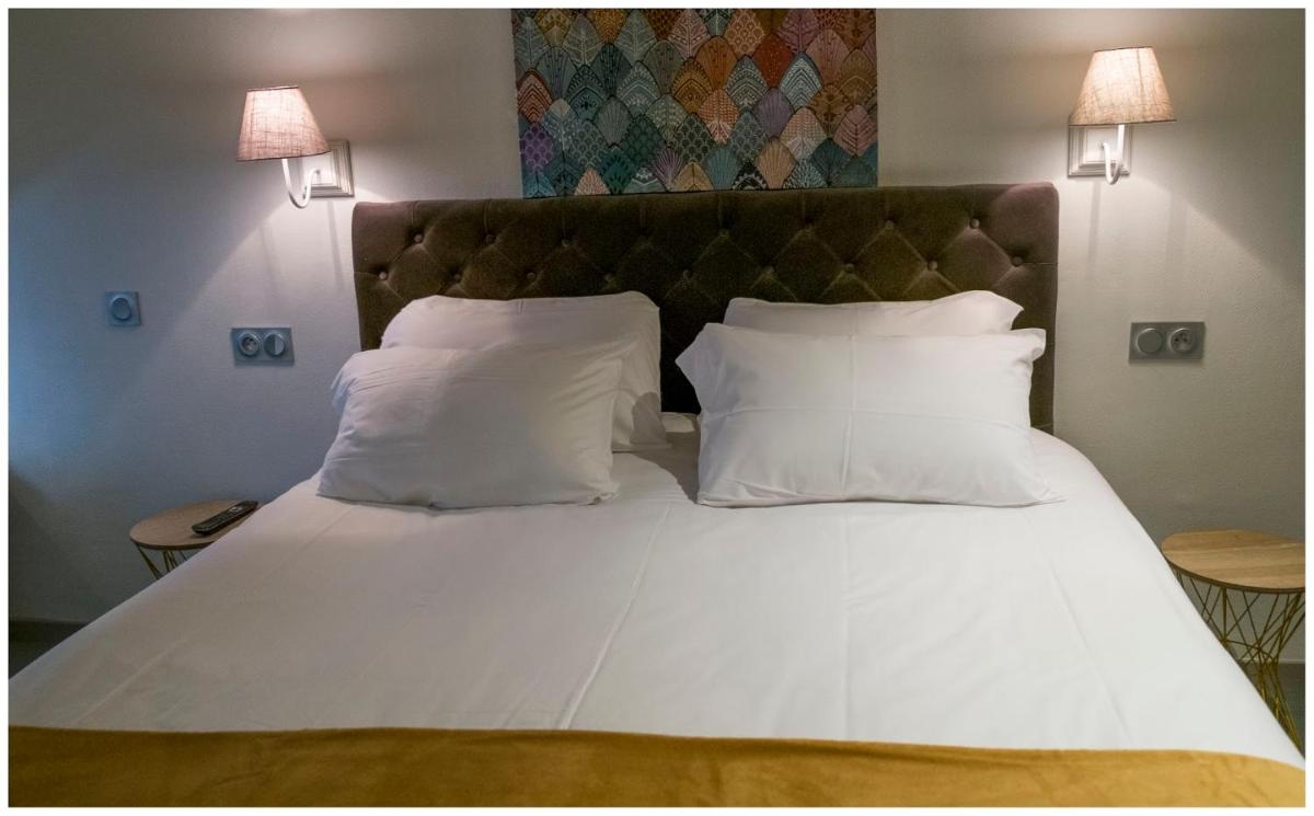 Un ou plusieurs lits dans un hébergement de l'établissement Hotel Corrieu