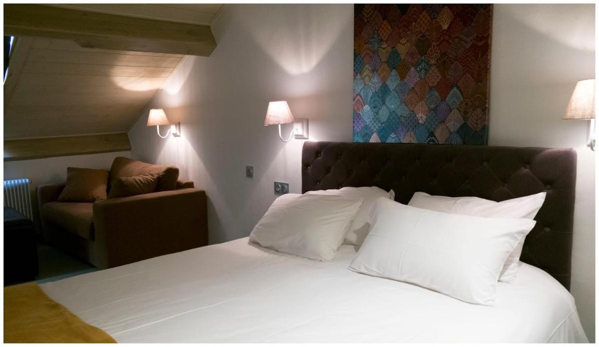 Un ou plusieurs lits dans un hébergement de l'établissement Hotel Corrieu